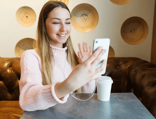 girl waving while on the phone