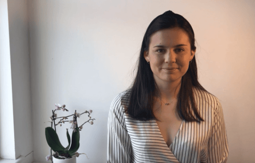 girl standing next to the orchid pod