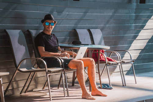 men working on laptop outside