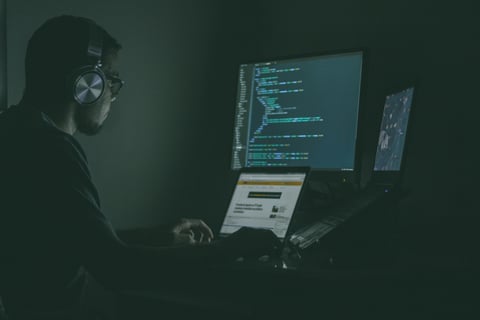 Developer working on real-world cybersecurity projects involving code and network analysis