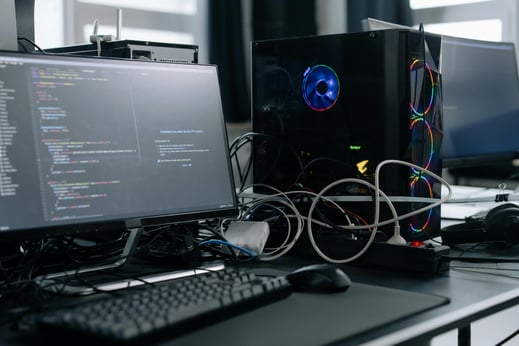Computer setup with monitors and cables—illustrating the need to prepare IT access before an intern’s first day.