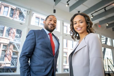 Confident early-career professionals in a modern workplace, challenging the myth that top talent is hard to find.