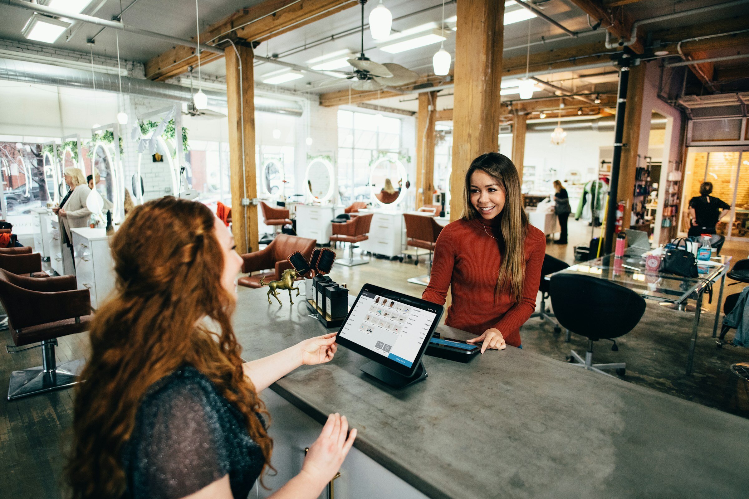 two professional women discuss hiring needs